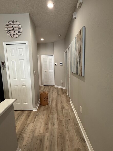 Hallway to 2nd guest bedroom and bathroom, laundry room + garage - 9410 Georgian Park Ln
