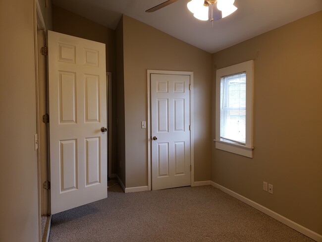 Bedroom 1, vaulted ceiling, spacious closets - 103 W 12th St