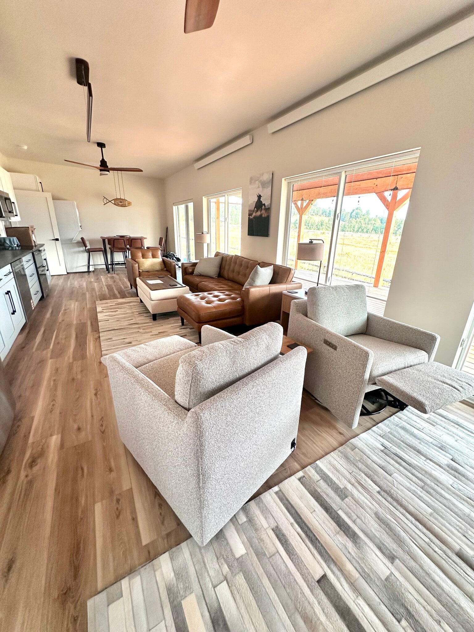 Recliners in front of large TV and fireplace also swivel to kitchen fun. - 53 Riverview Cir