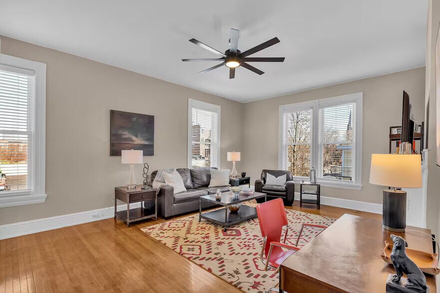 Living room with large windows, tall ceilings, gleaming original floors and insulated windows. - 1104 Cross Ln