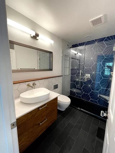 Master bath with custom tile and European style wall mounted vanity and toilet. Dimmable LED lights. - 1641 N Washington St