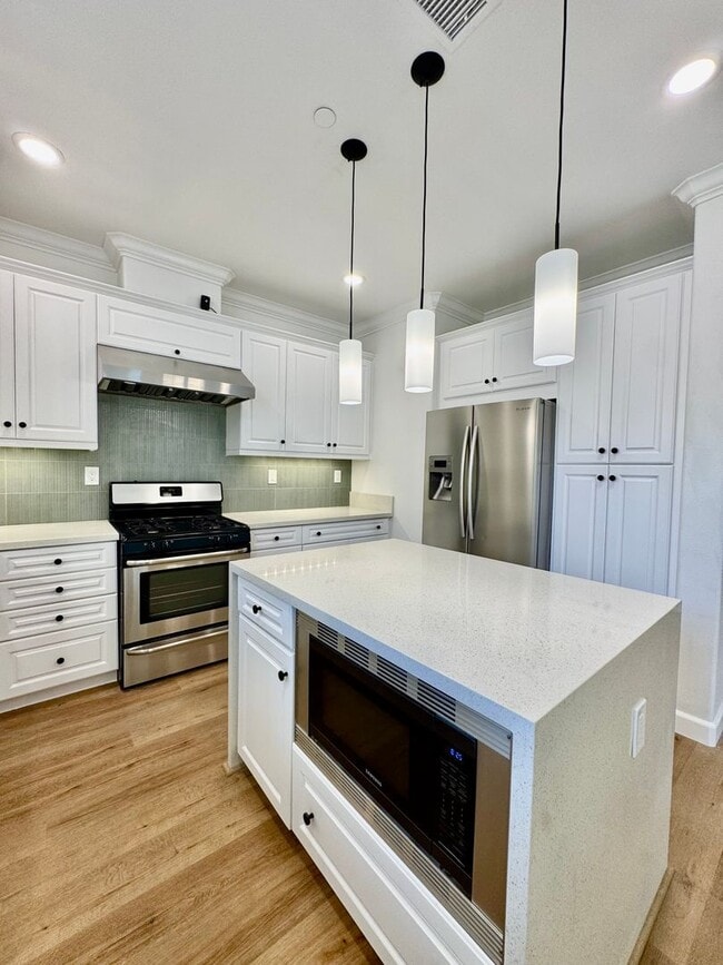 Building Photo - Beautifully Remodel Townhouse with AC & Two Car Garage!