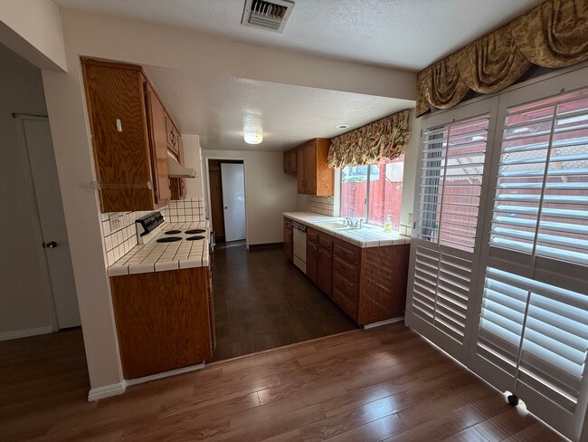 Efficient galley kitchen with abundant cabinetry and natural light - 1134 W Huntington Dr