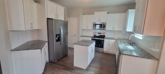 Building Photo - Spacious Elegance Awaits: 4-Bedroom Gem with Granite Countertops on Harrington Road!