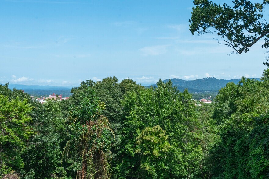 From the master bedroom suite enjoy the breathtaking panoramic vista showcasing tree-lined horizons, - 405 Windswept Dr