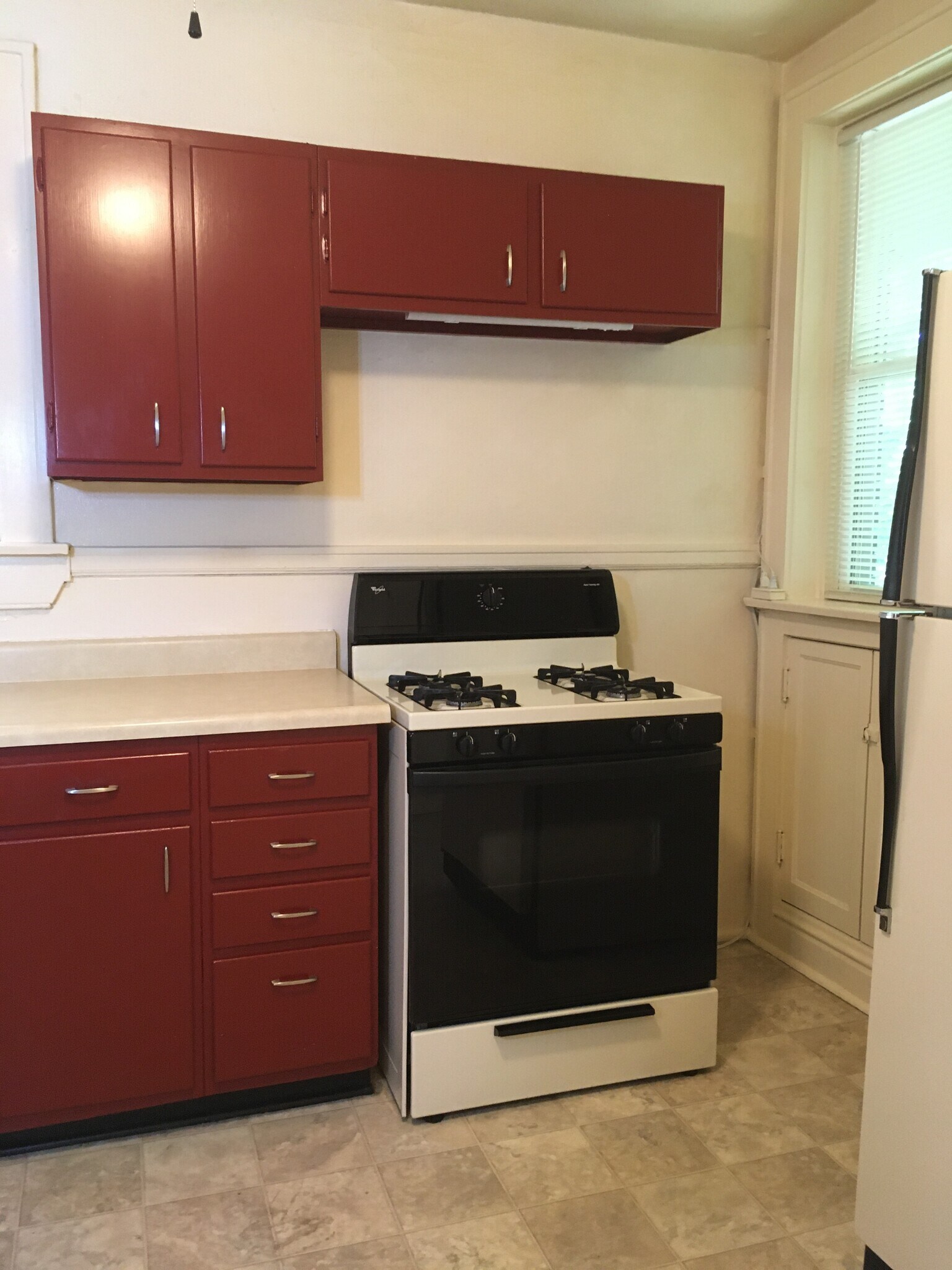 Kitchen features full size refrigerator and gas stove/oven - 4973 Tholozan Ave