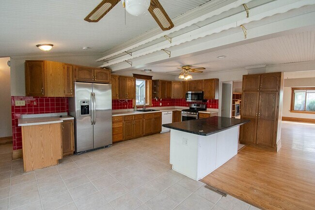 Building Photo - Bright, beautiful home with 3 garage spaces & tons of storage!