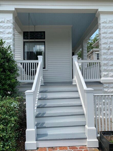 Welcoming front porch with swing and attached driveway - 1316 Pleasant St