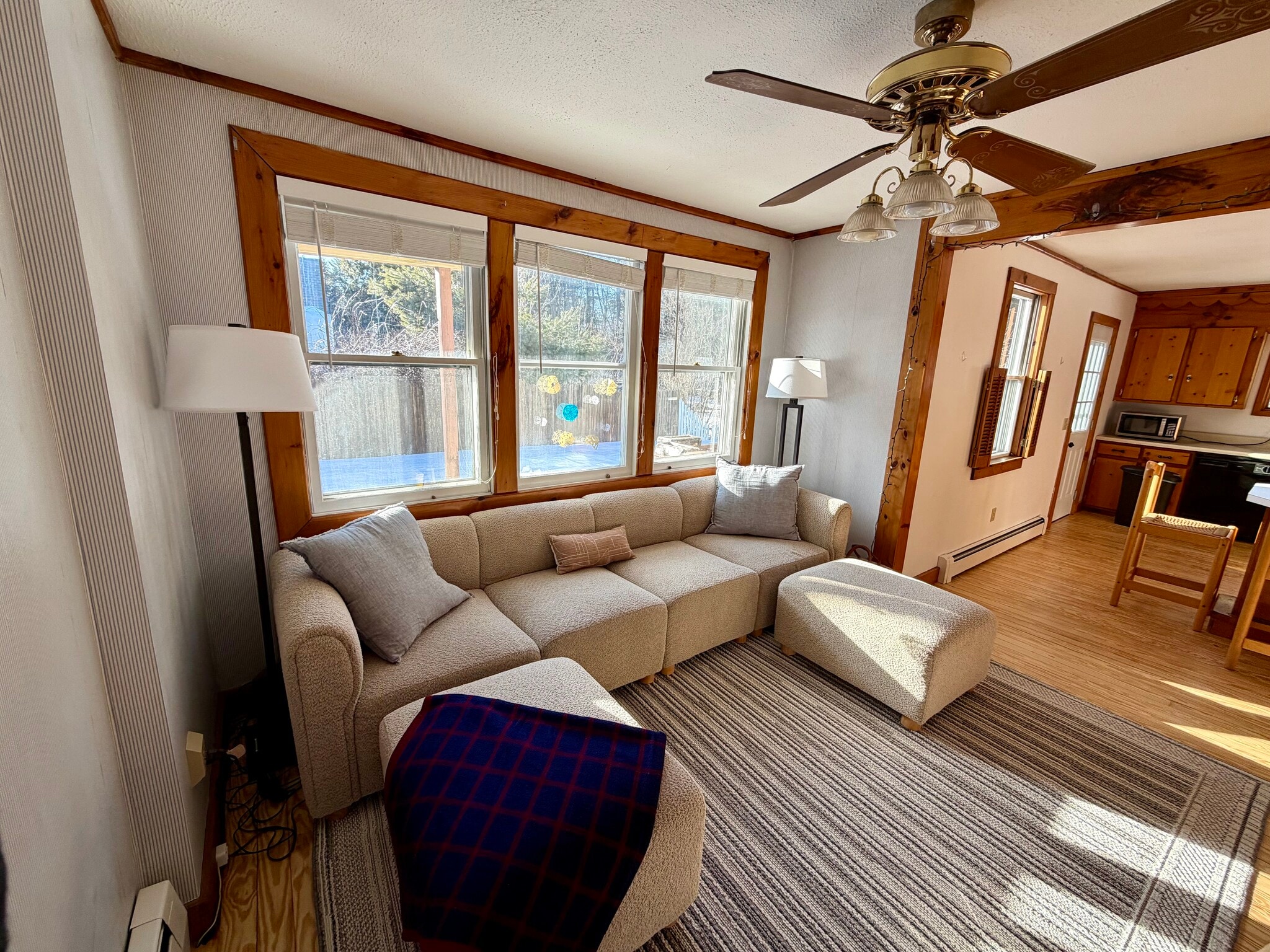 living area with large couch and ottomans - 34 Boody St