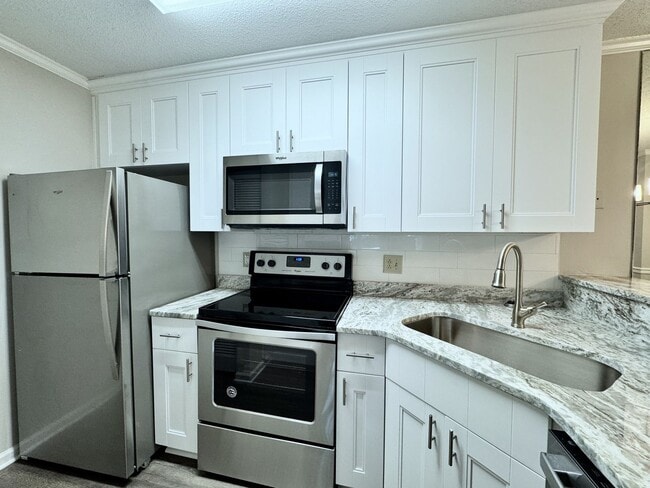 Building Photo - Updated 1st Floor/1-Level Condo Available NOW & Rent Includes Water, Sewer, Trash, Landscaping, F...