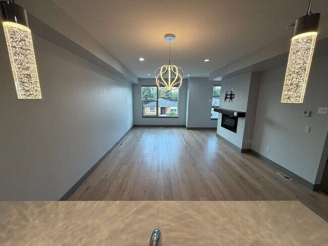 Building Photo - ~Available Now~ Modern 2-Bed Townhouse with Scenic Views near City Park - built in EV charger!