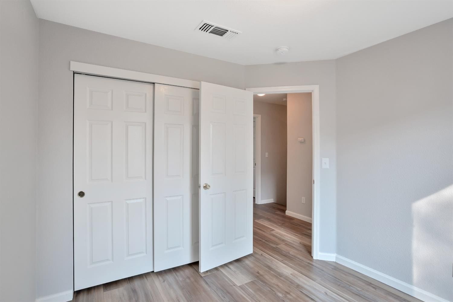 The view of one of the upstairs bedroom's closet & doorway. - 3038 Courtside Dr