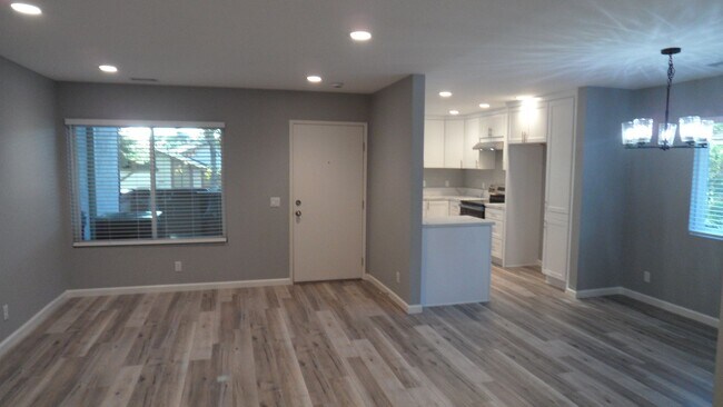 Building Photo - REMODELED 2BR; 1BA end unit condo w/ 1 car garage & 1 parking space