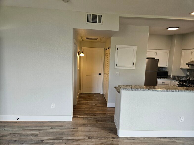 Hallway to main bathroom, washer/dryer to right, door to 2nd bedroom on left - 2251 Wigwam Pky