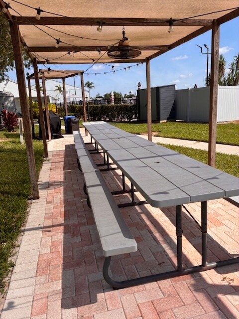 The picnic area features durable compressed wood, offering a stylish and low-maintenance space for o - 9570 Green Cypress Ln