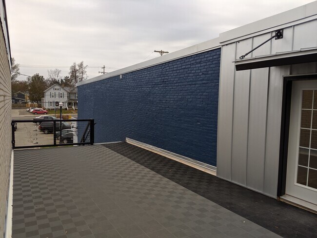 Shared patio area, entrance to apartment. - 130 E State St