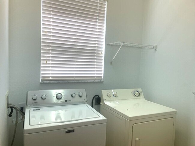 Building Photo - Elegant 3 Bedroom End-Unit Condo with Screened Lanai & Pond Views and A Private Garage