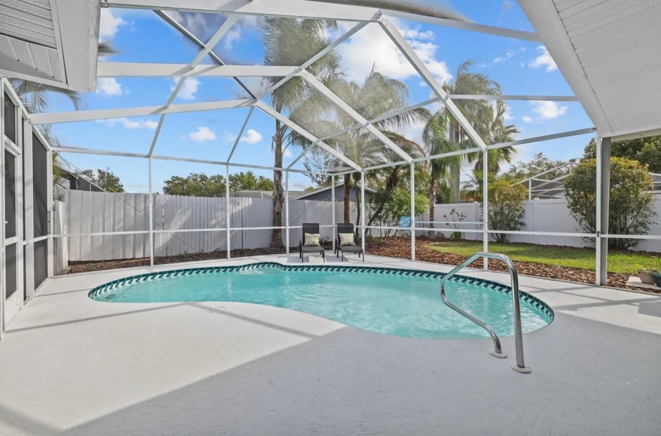 Screened-in private pool with large lounging area — your personal oasis. - 1932 Brainerd Ct