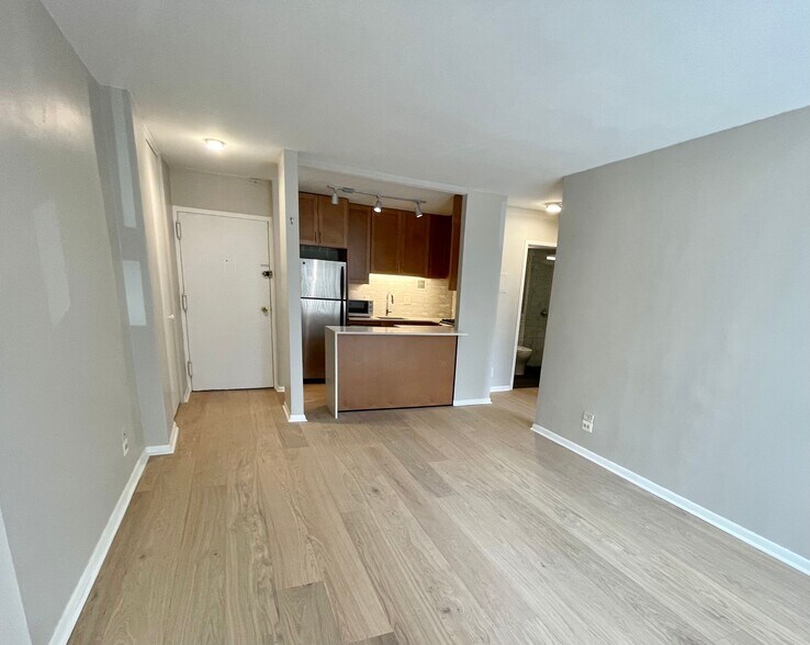 Living room view to kitchen; new wood floors - 1260 21st St NW
