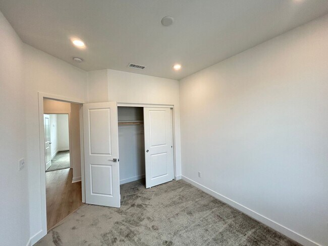 Building Photo - Gorgeous, 3 level townhome, featuring 2 car garage central Air, and in Unit laundry.