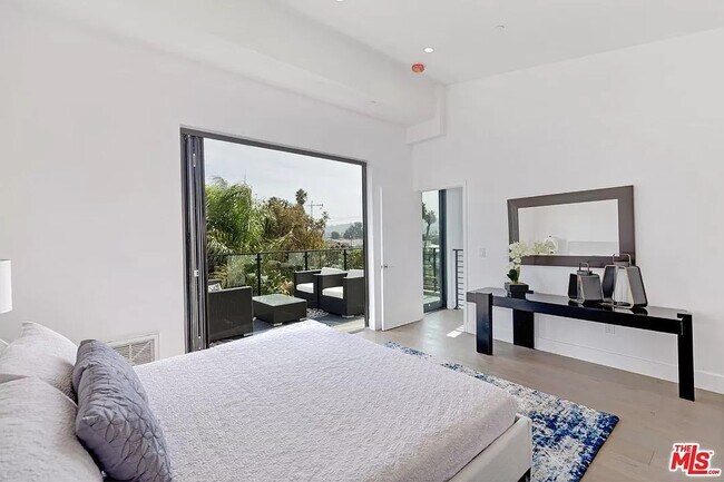 Outdoor patio can be accessed without entering the primary bedroom. Not pictured: smart roller blind - 6077 Hargis St