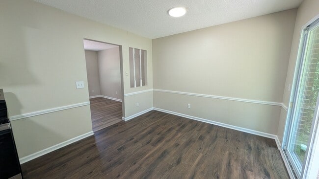 Building Photo - Fenced Yard, Lots of Light, Hard Floors Throughout