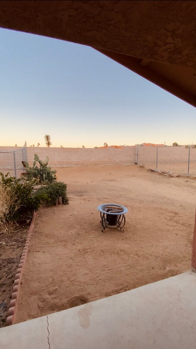 Backyard with small fire pit and BBQ included - 7245 Murray Ln