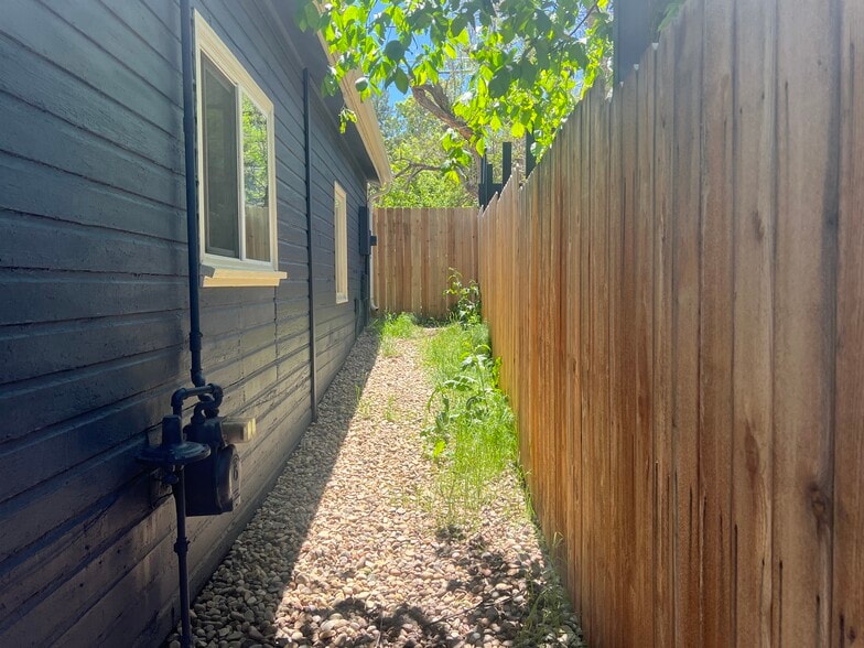 Exterior storage area along west side of the home. - 920 University Ave