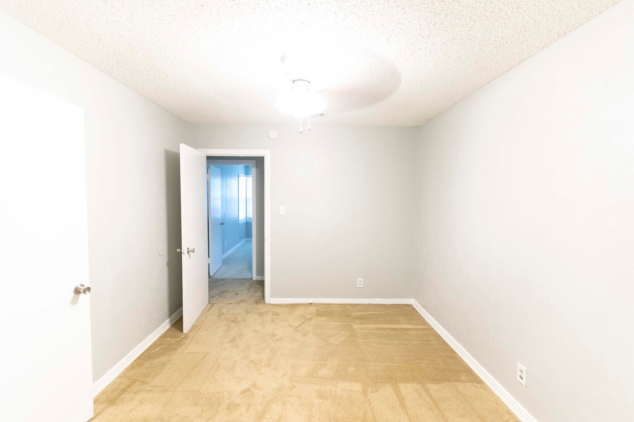 Bedroom 1 looking into living area 1, through hallway. - 7459 Mohawk Ave