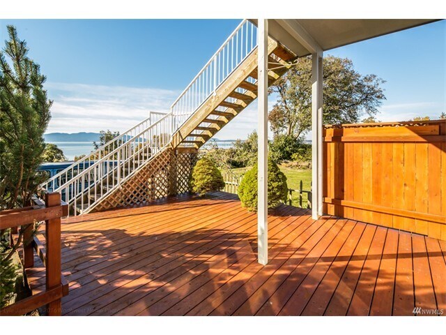 This is the spacious deck of the lower unit, which is partially covered, showing the stairway to the upper unit. - 2809 Eldridge Avenue