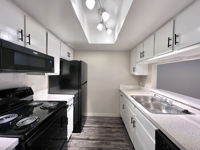 Experience culinary delight in this sleek, modern kitchen equipped with top-tier amenities. - Inertio Apartments