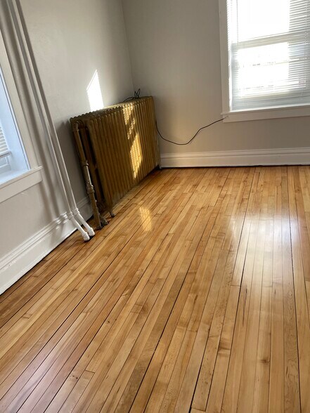 Back bedroom newly refinished hardwood floor - 432 E 7th St