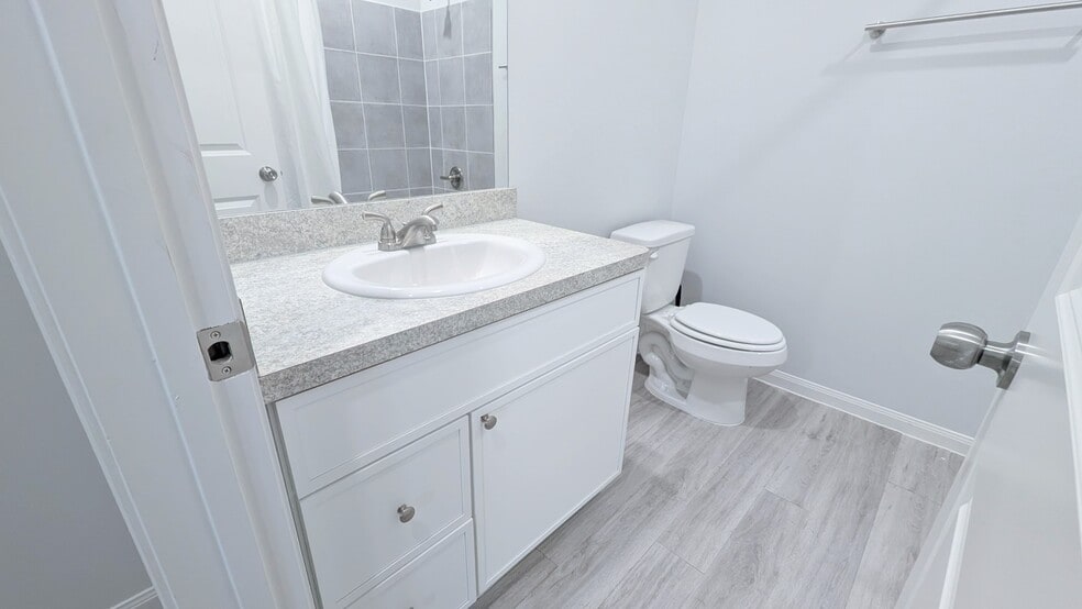 Upstairs full bathroom has a shower/tub combo and vanity with extra storage space. - 13218 HP Johnson St