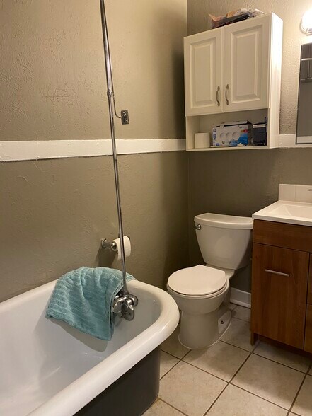 Bathroom with 1900 claw tub. - 919 Massachusetts St
