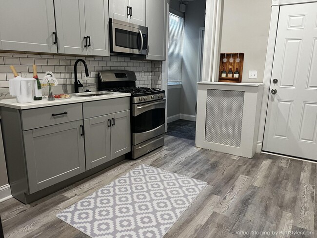 Kitchen w/granite countertop and stainless steel appliances - 3529 Roland Ave