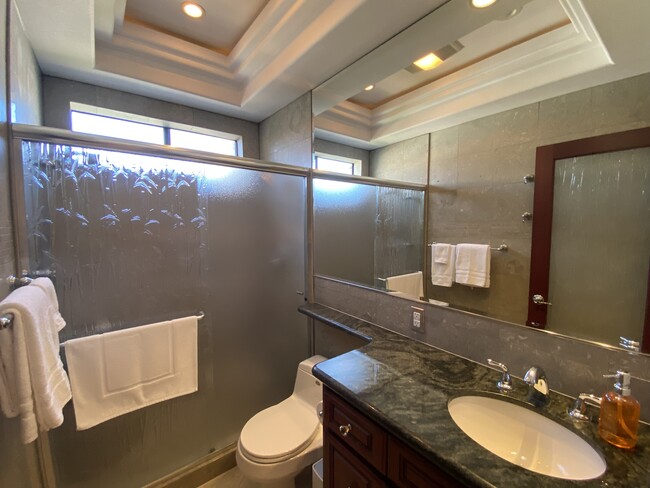 Guest bathroom - limestone walls, granite counters and shower seat - 5146 Dorado Dr