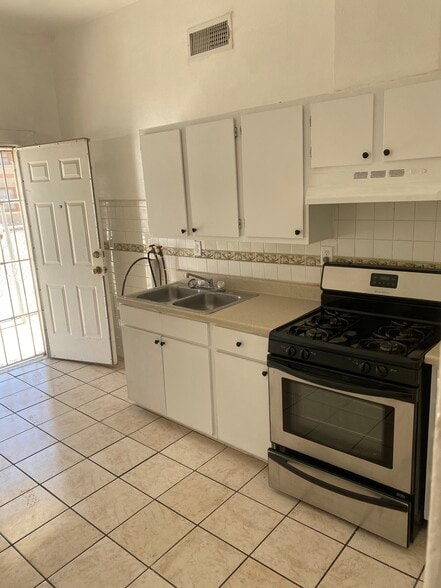 Kitchen has stove and Refrigerator. Side entrance - 1407 E San Antonio Ave