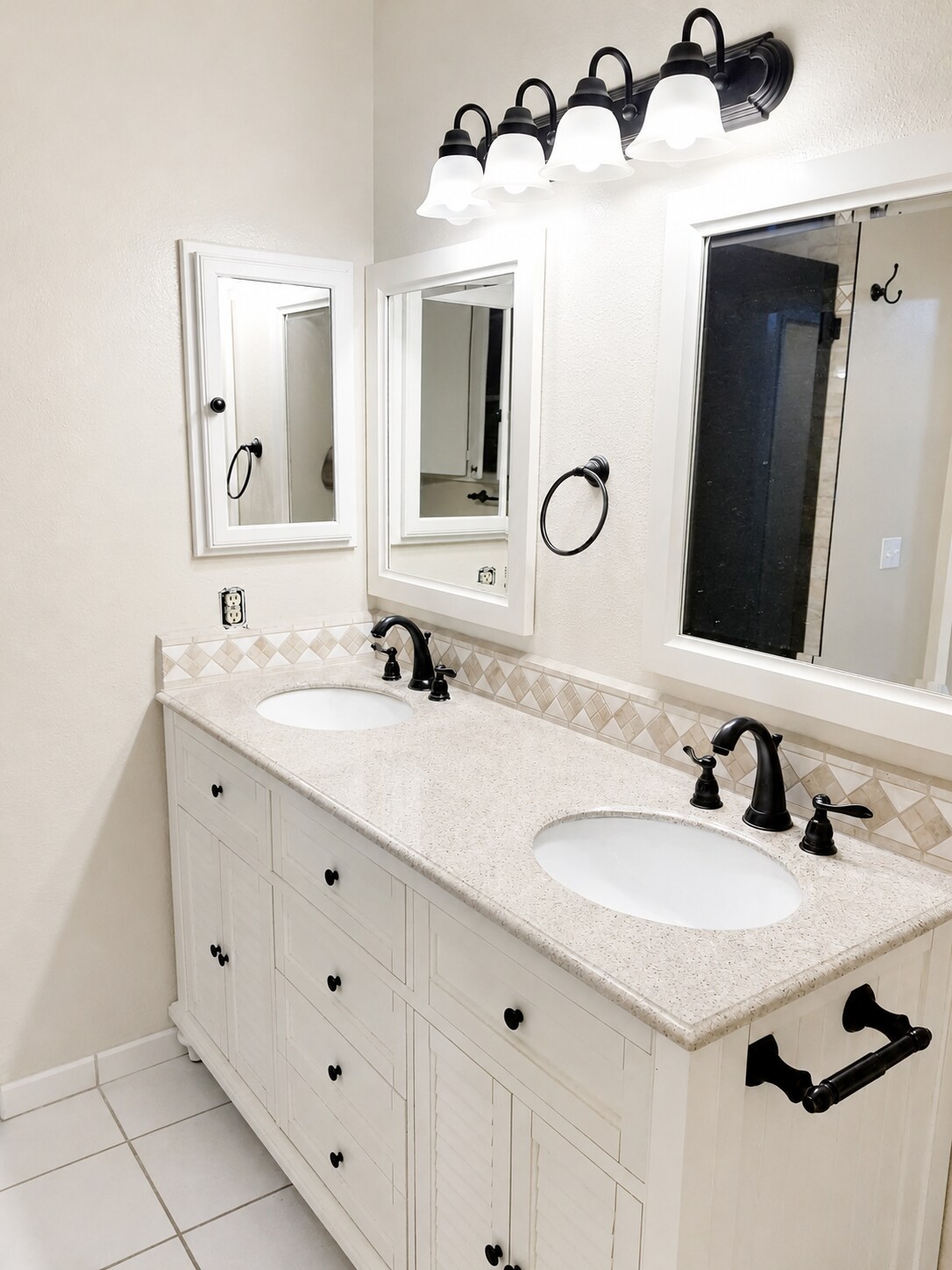 Bathroom vanity with updated countertop, storage cabinets, and mirror. - 339 E Taft Ave