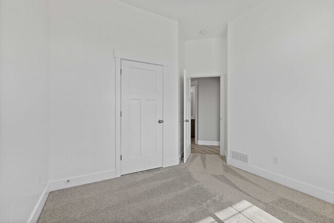 Building Photo - NEW HOME with large garage stalls and unfinished basement for additional storage