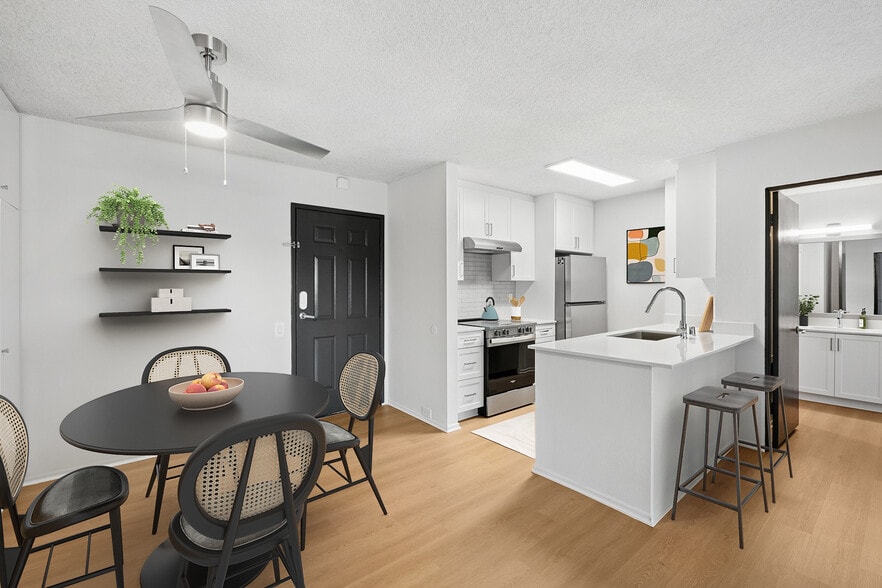 Renovated Package II kitchen and dining room with updated hard surface flooring - AVA Pacific Beach