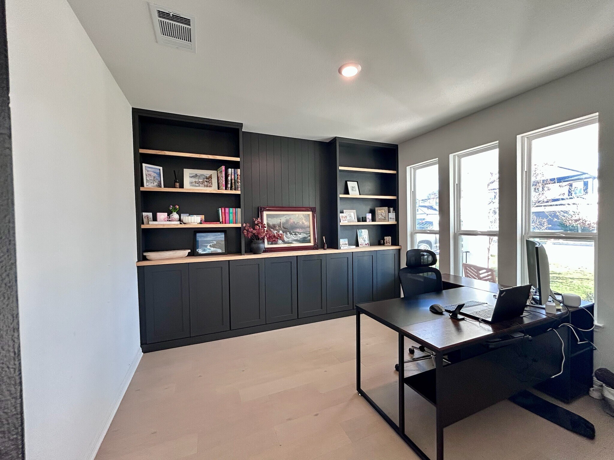 Dedicated home office with custom built-ins, abundant natural light, and a front-facing view. - 517 Moonlit Stream Pass