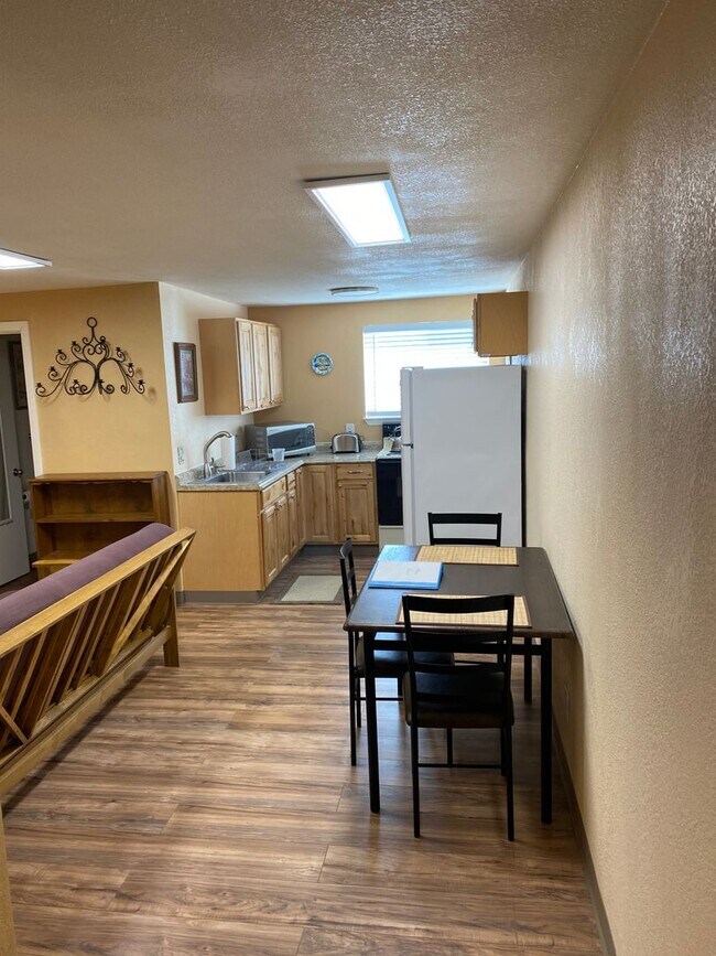 Building Photo - Adorable studio with large garage and work...