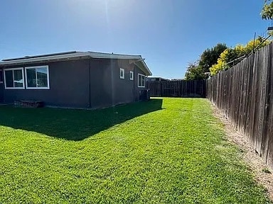 Large backyard with lush green lawn - 27596 La Porte Ave