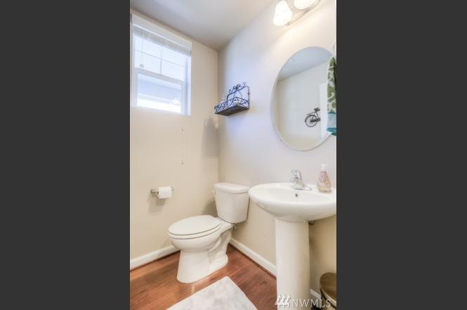 Powder room, by front door, and garage door entry. - 8828 Jayden Ln NE