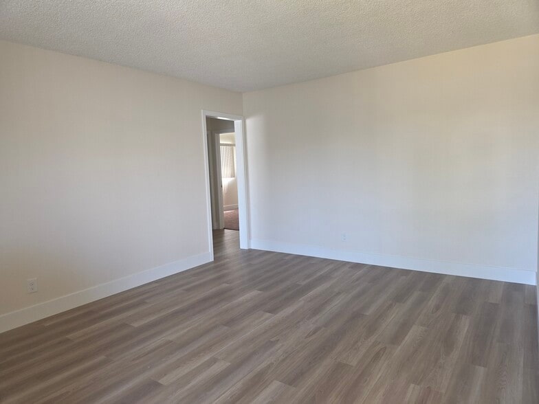 Living room with plank flooring - 5530 Ackerfield Ave
