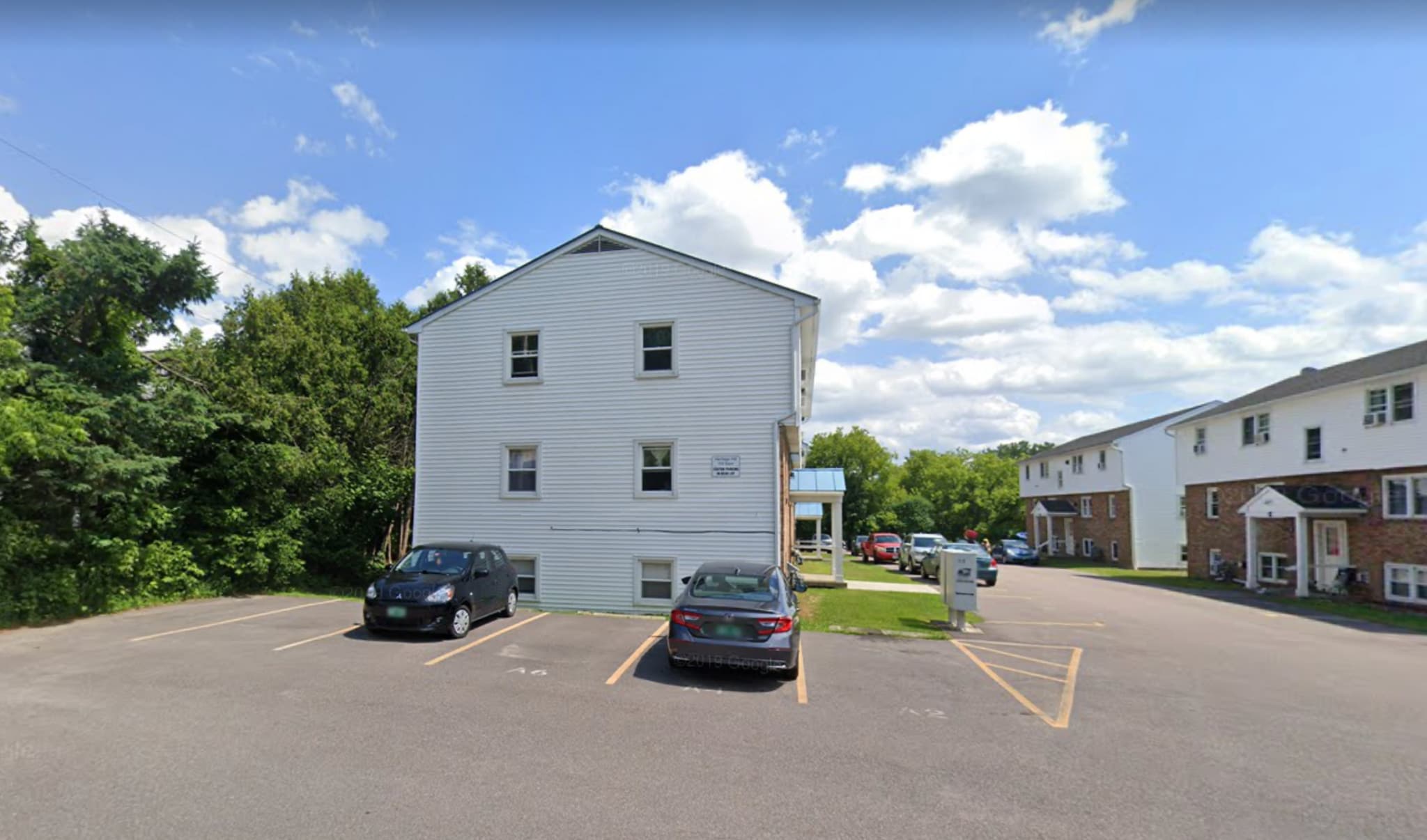 119 Main Street 4A outside, with covered front entrance. Tenants are guaranteed one parking spot next to unit, and spot(s) in the rear of association lot. - 119 Main St