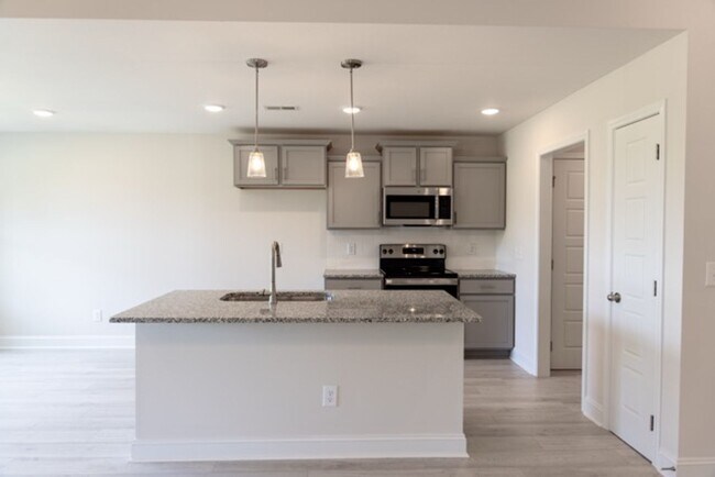 Building Photo - Modern Living Redefined with Stone Fireplace, Gray Cabinetry, Spa Inspired Primary Suite and Cove...