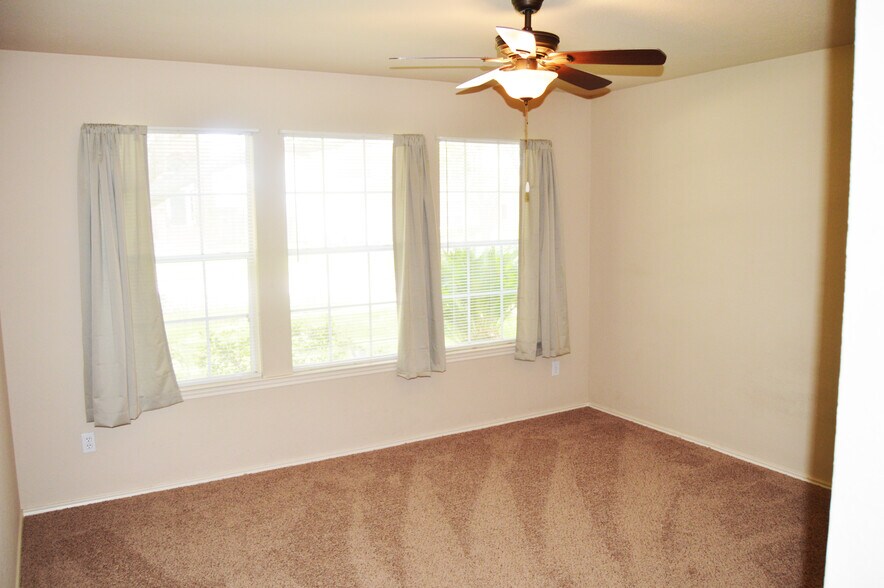 Bedroom 1 has 3 nice large windows and is located in the front of the home. - 23035 S Waterlily Dr