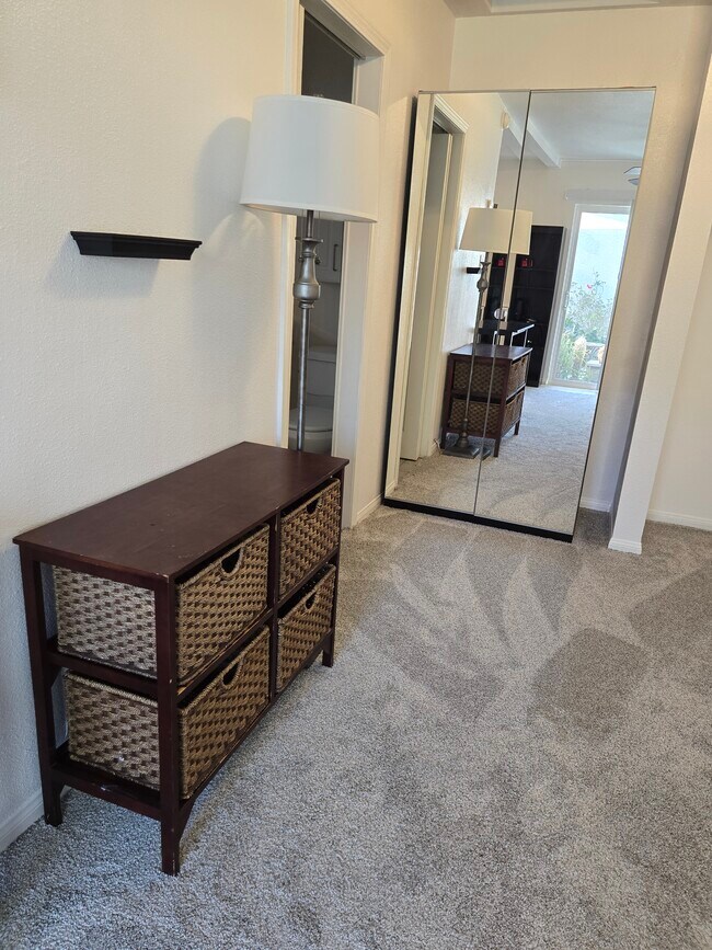 View of dresser and closet. Three large cabinets above bed area. - 7649 Beckett St