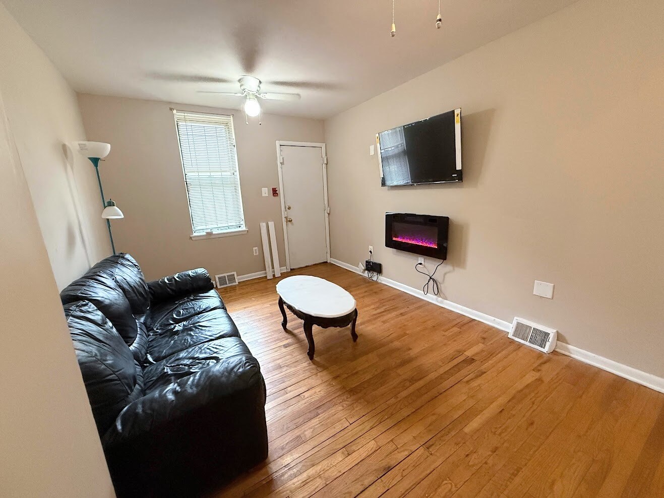 Apt 1 - Living Room comes with TV and Fireplace - 2148 N Carlisle St